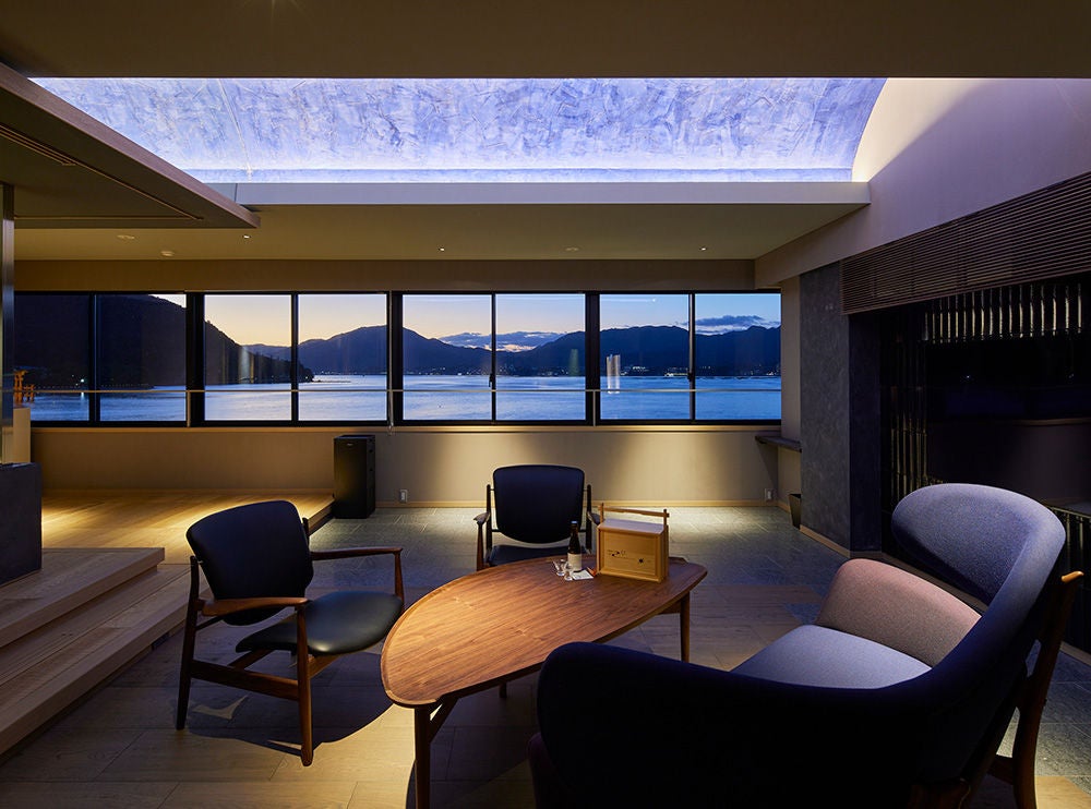 Traditional Japanese ryokan with elegant wooden facade, featuring sliding paper doors and warm lantern lighting along a narrow street