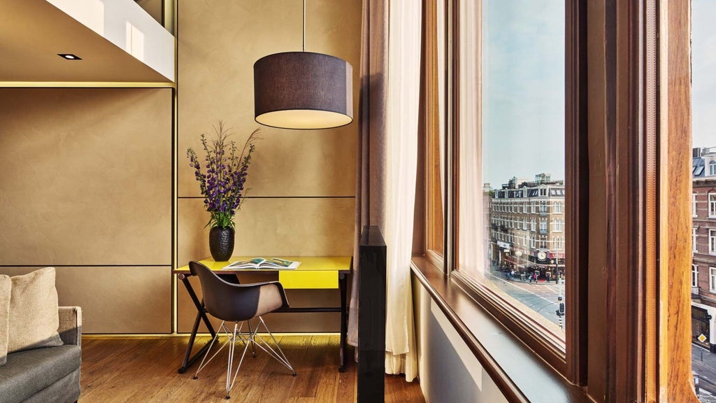 Luxurious duplex room at Conservatorium Hotel, Amsterdam, featuring modern design with high ceilings, wooden floors, and minimalist contemporary furnishings