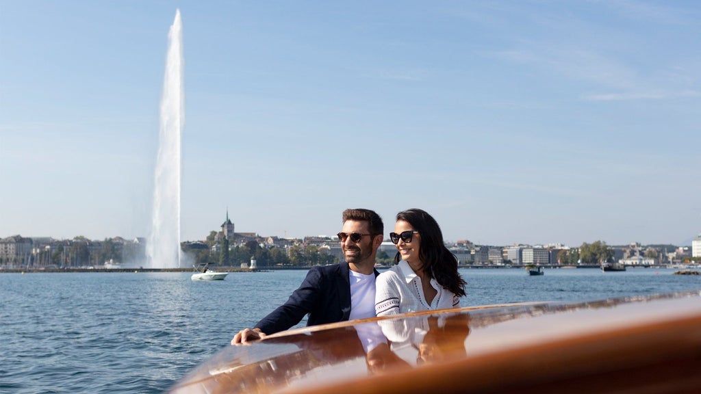 Luxurious lakeside hotel with modern architecture, panoramic lake views, and elegant spa surrounded by Swiss landscape near Geneva.