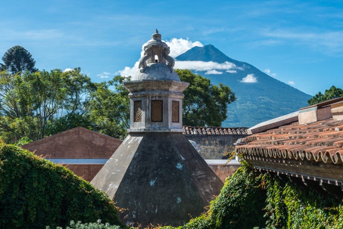 Colonial buildings with the towering volcano