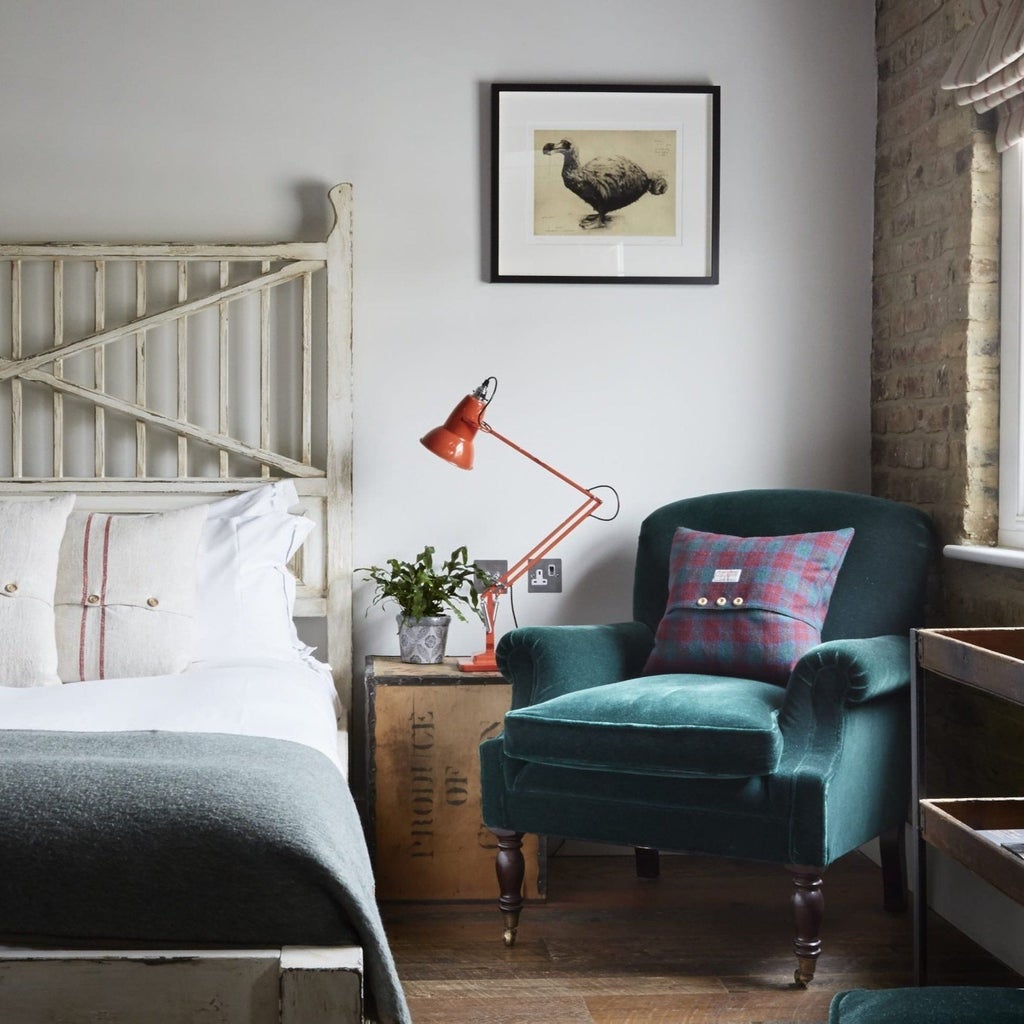 Luxurious boutique hotel room with eclectic artwork, vintage furnishings, and vibrant design elements in a chic London neighborhood setting