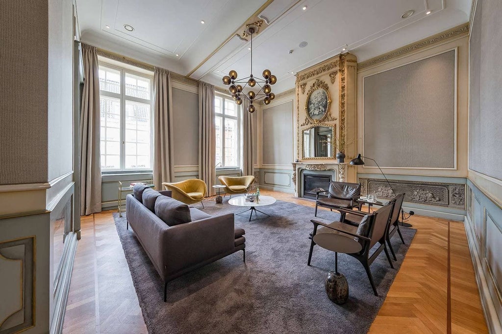 Luxurious hotel lobby with modern Belgian design, featuring plush seating, elegant marble floors, and soft ambient lighting in Brussels city center