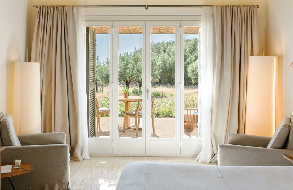 Elegant white-walled Spanish hotel room with minimalist design, crisp linens, natural light, rustic wooden furniture, and panoramic countryside view