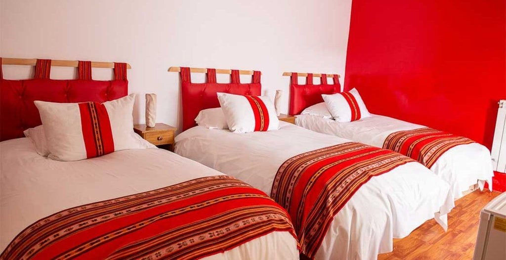 Spacious superior triple hotel room with elegant Bolivian decor, warm earth tones, three comfortable beds, and minimalist eco-friendly design