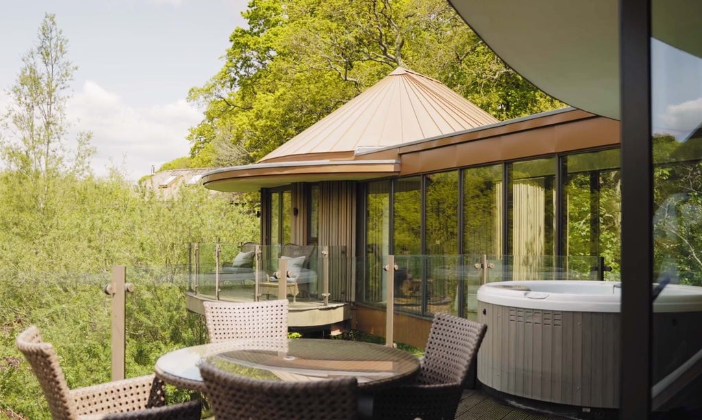 Luxurious wooden treehouse suite with floor-to-ceiling windows overlooking lush forest, modern minimalist decor and elegant natural light streaming inside