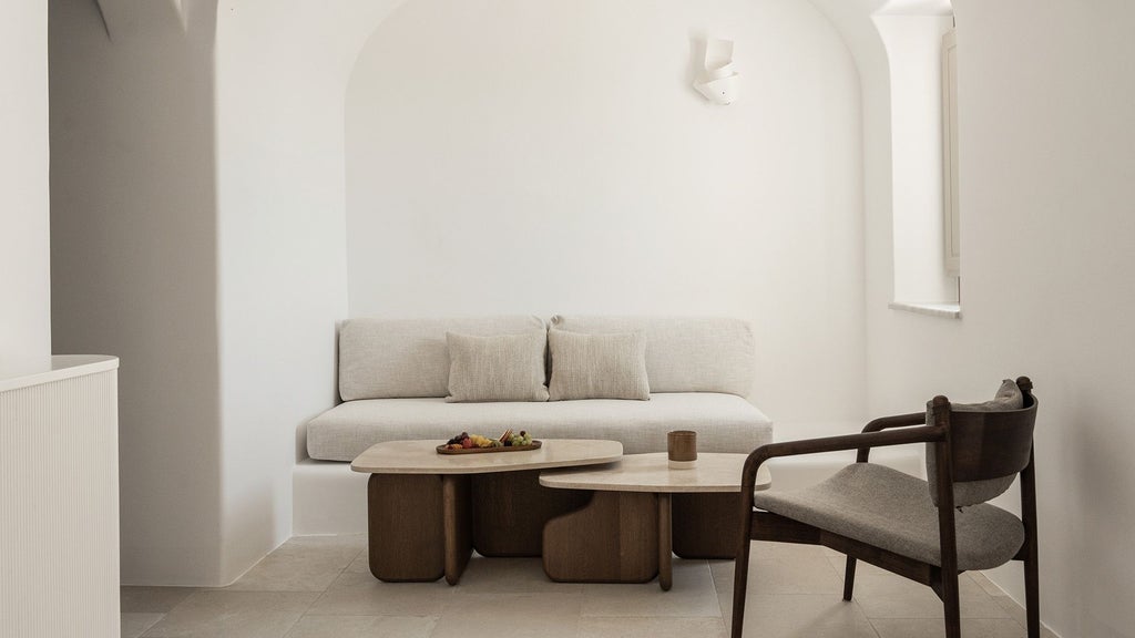 Luxurious white-washed Cycladic honeymoon suite with private infinity pool overlooking azure Aegean Sea in scenic Oia, Santorini, Greece