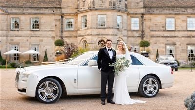 Elegant luxury hotel nestled in lush Yorkshire countryside, featuring grand Georgian architecture, manicured gardens, and pristine white exterior