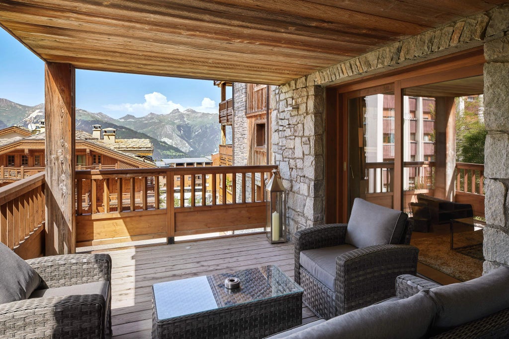 Luxurious alpine ski resort with modern chalet-style architecture, snow-covered mountains, and elegant Six Senses design in Courchevel's pristine winter landscape