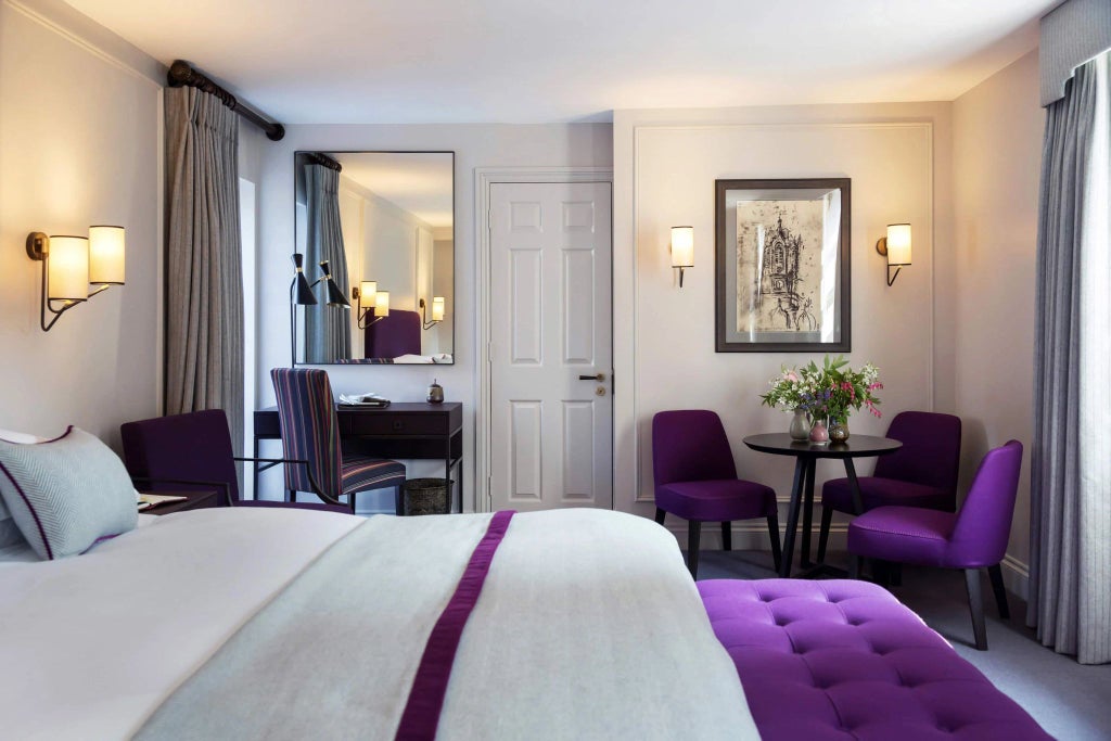 Elegant classic room with crisp white linens, period furnishings, and soft natural light in the historic Old Parsonage Hotel, United Kingdom.