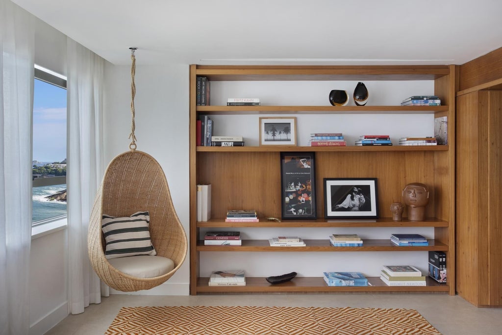 Luxurious modern hotel room at Janeiro Hotel with sweeping ocean views, minimalist design, floor-to-ceiling windows, and elegant white and wood interior decor