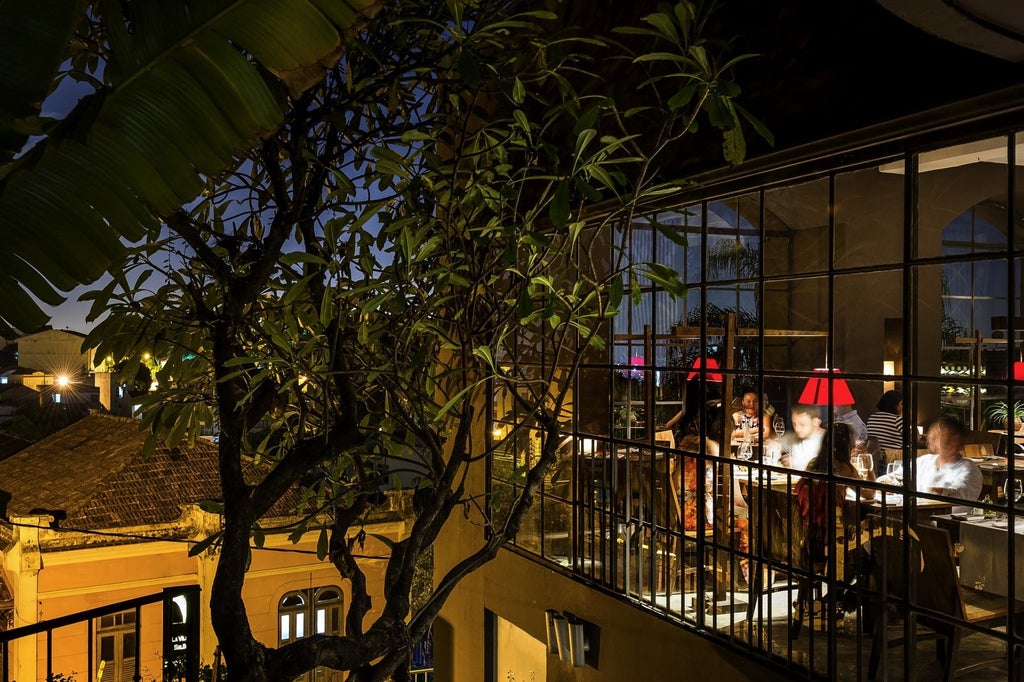 Elegant junior suite at Santa Teresa Hotel RJ, featuring luxurious Brazilian decor with soft neutral tones, modern furniture, and warm ambient lighting