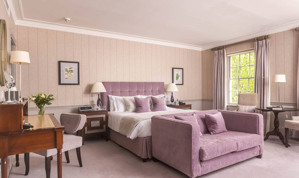 Elegant Georgian-style heritage room at Royal Crescent Hotel, showcasing antique furnishings, soft cream walls, and refined period decor with luxurious textiles