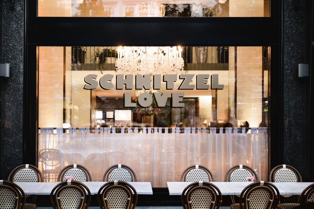 Elegant marble lobby of Grand Ferdinand hotel in Vienna, Austria, featuring opulent chandeliers and classic Art Nouveau architectural details with luxurious golden accents