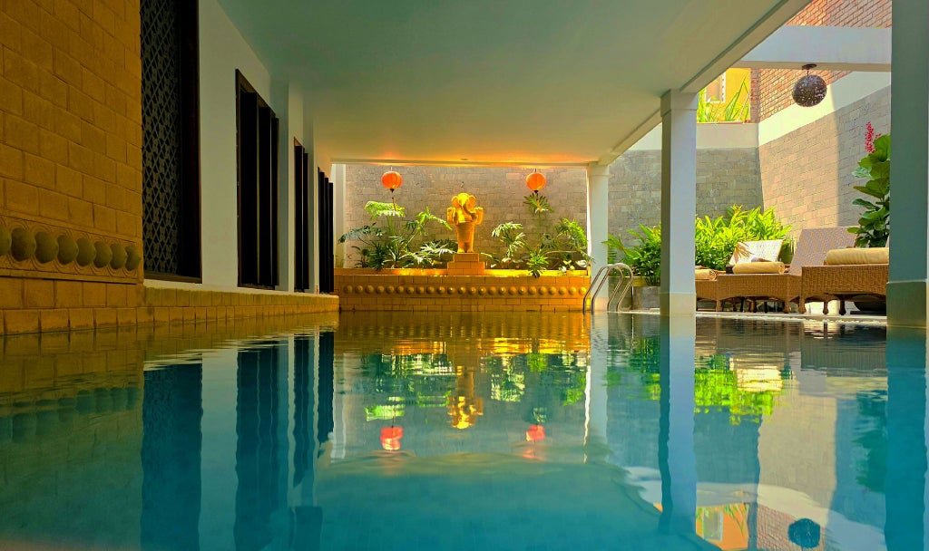 Elegant Vietnamese boutique hotel with traditional architecture, lush tropical gardens, and serene spa reflecting Hoi An's historic charm and luxurious hospitality