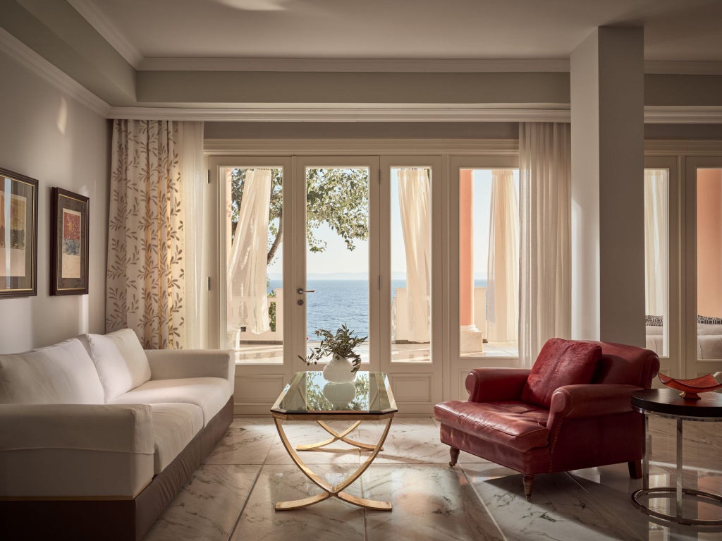 Luxurious Mandarin Villa at Danai Beach Resort, featuring elegant white interiors, sea-view balcony, and modern Greek coastal design with premium furnishings