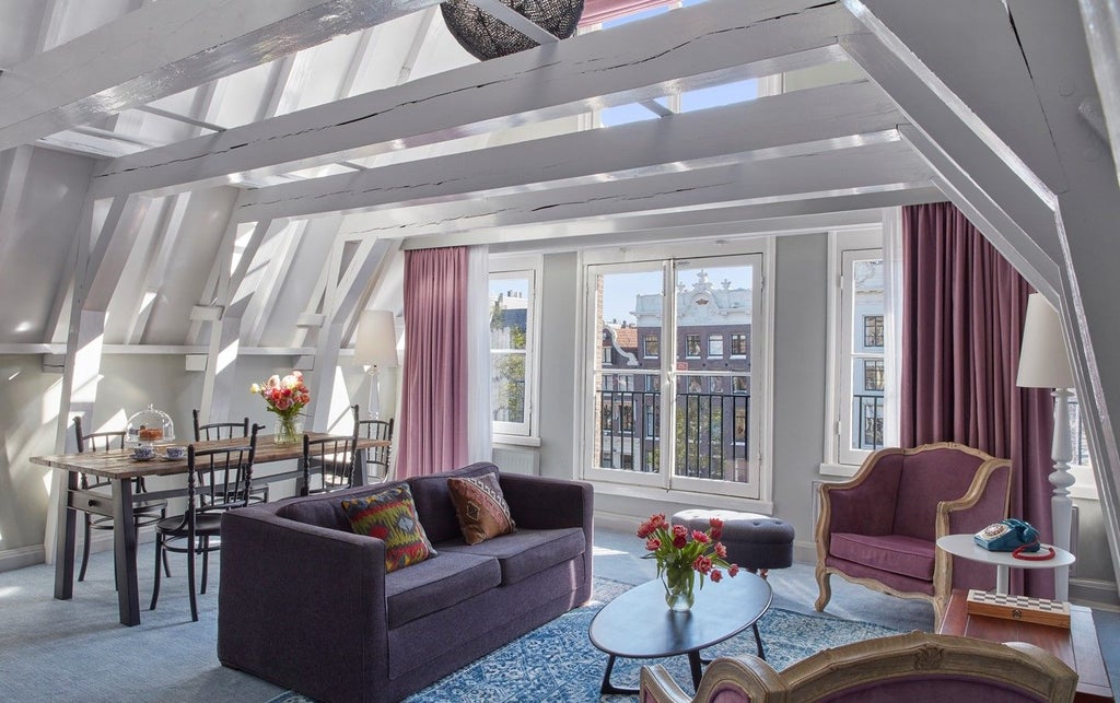 Elegant family suite with canal views, featuring classic Dutch decor, plush furnishings, exposed beams and modern lighting fixtures