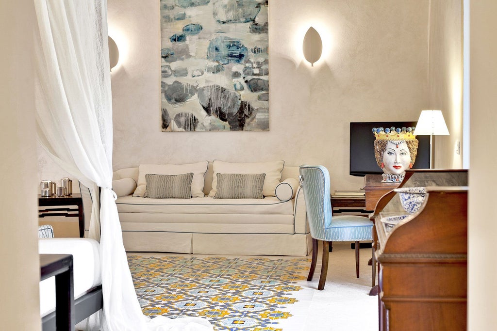 Elegant Sicilian stone-walled hotel room with soft cream linens, arched window, and minimalist design showcasing traditional Mediterranean luxury and serene comfort