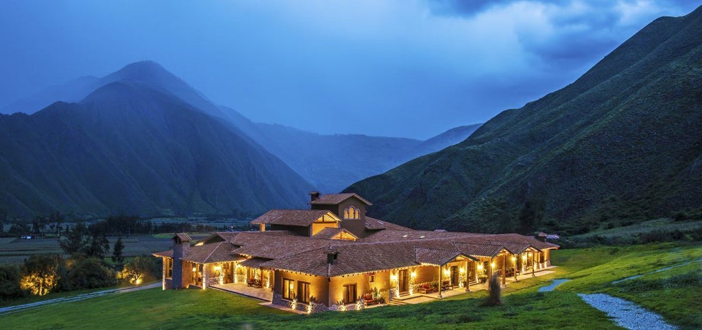 Luxurious mountain lodge nestled in Peru's Sacred Valley with panoramic Andes views, stone walls and traditional colonial architecture