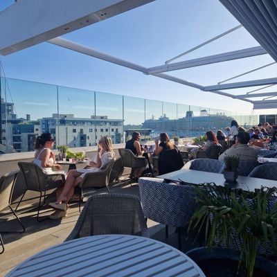 Luxurious waterfront hotel with modern architecture, overlooking Southampton harbour with sleek glass facade and elegant maritime-inspired design