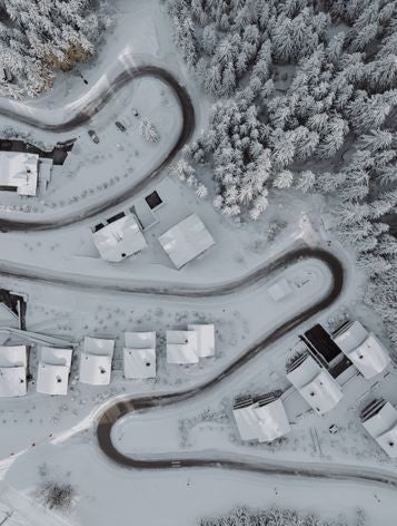 Luxurious alpine ski resort hotel with snow-capped peaks, sleek modern architecture, glass windows, and elegant exterior in Courchevel, French Alps