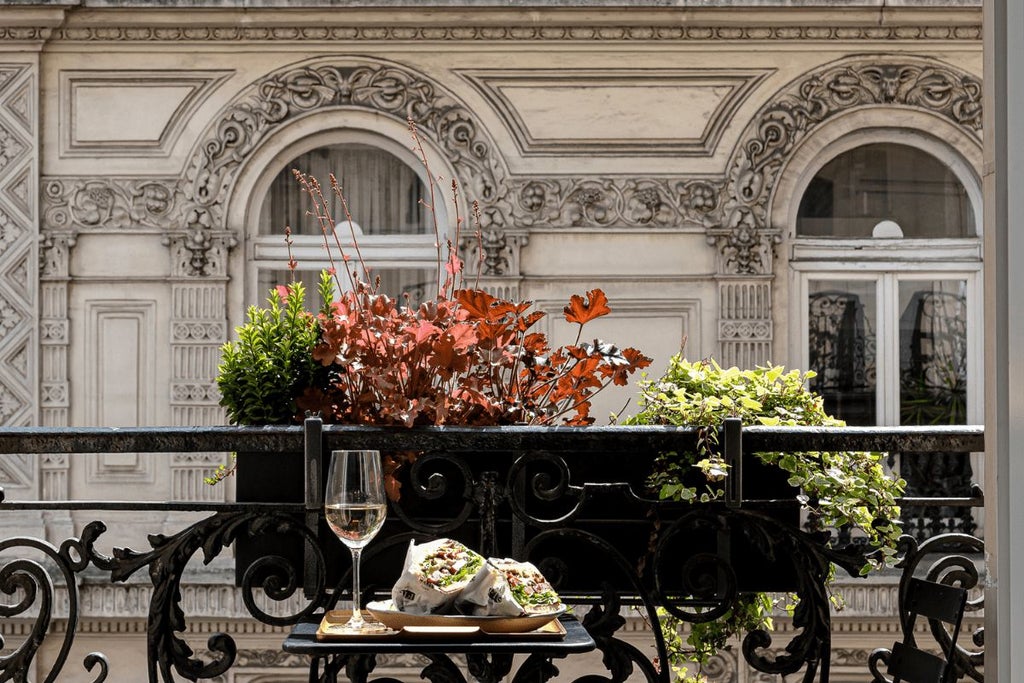 Elegant Parisian boutique hotel with Art Deco-inspired facade, soft pastel colors, and chic wrought-iron balconies in the vibrant Grand Pigalle neighborhood