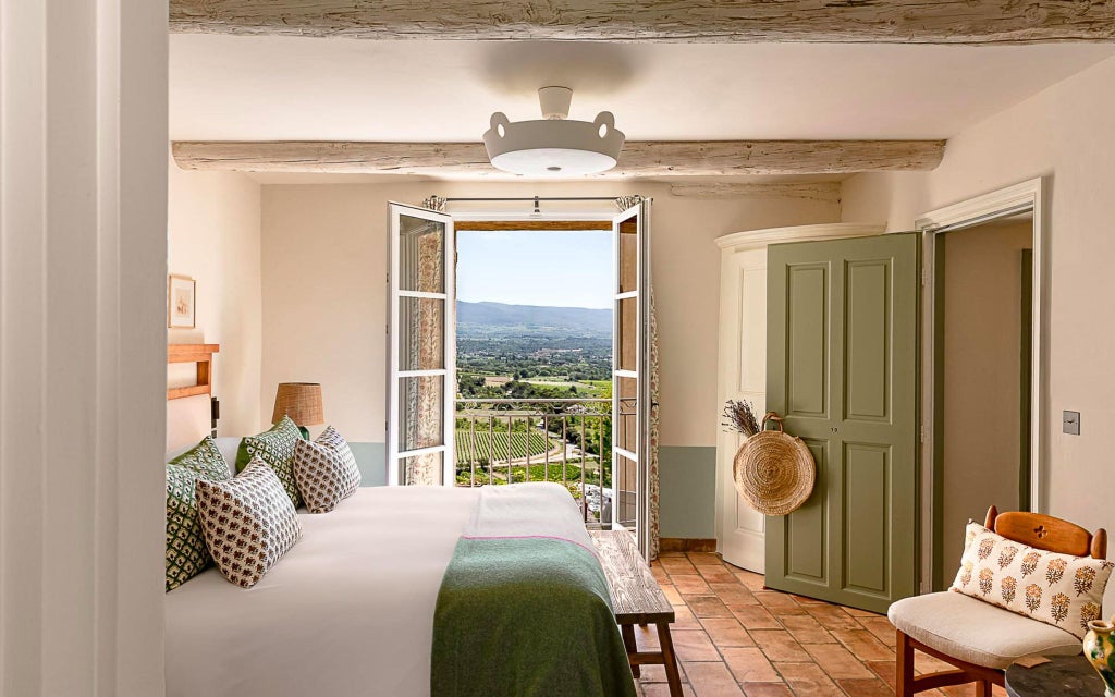 Lavish terracotta-tiled rooftop of elegant Lou Pinet hotel in Saint-Tropez, with lush Mediterranean gardens and pristine azure swimming pool nestled among stone walls