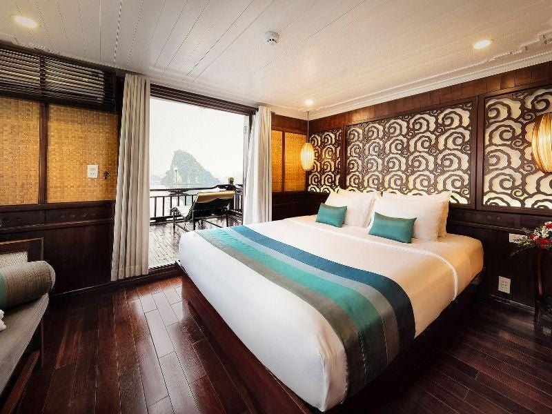 Elegant Terrace Suite aboard Bhaya Cruises, featuring panoramic views of emerald waters, luxurious contemporary design, and traditional Vietnamese maritime charm.