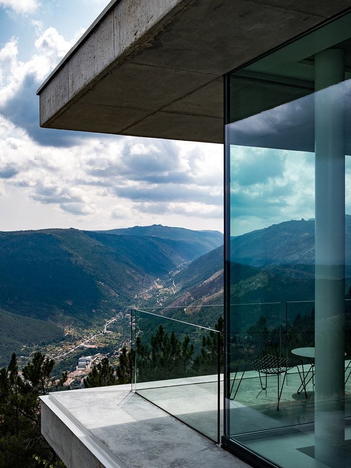 Luxurious mountain retreat nestled in scenic Portuguese landscape, showcasing modern white architecture with panoramic alpine views and elegant design elements