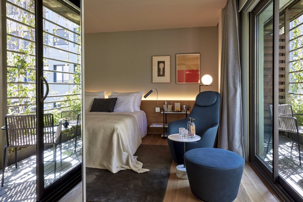 Modern, spacious deluxe hotel room with minimalist design, neutral color palette, floor-to-ceiling windows, contemporary furnishings, and elegant urban aesthetic in Spain