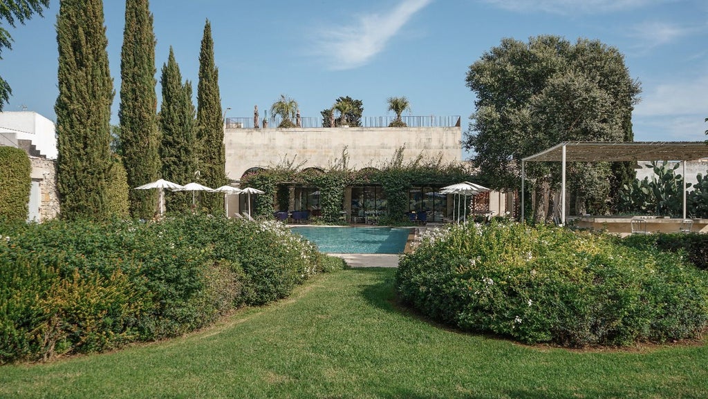 Elegant 18th-century palazzo with stone facade, arched windows, and lush courtyard garden in historic Italian countryside setting