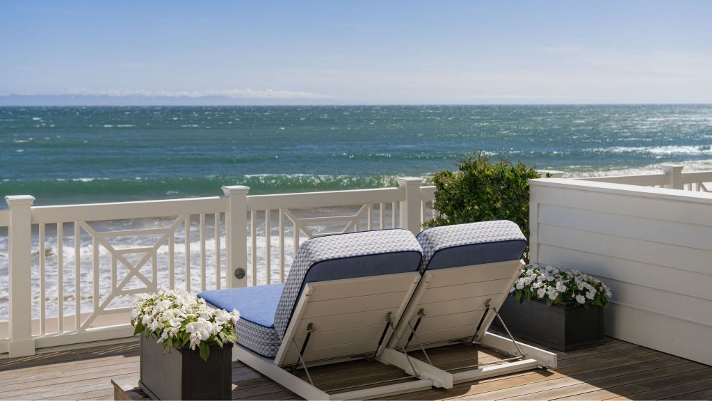 Luxurious beachfront terrace with elegant outdoor seating, overlooking Pacific Ocean, Rosewood Miramar Beach Resort's pristine coastal landscape in California