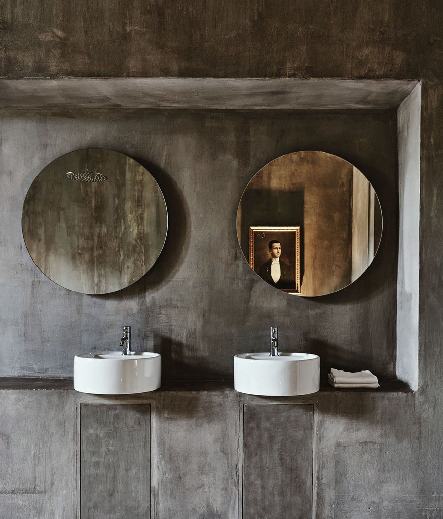 Elegant royal junior suite at Palazzo Daniele with ornate marble floors, antique furnishings, and soft natural light filtering through high windows in Southern Italy