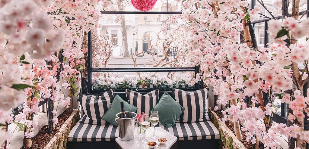 Elegant Victorian-era luxury hotel facade in central London, featuring ornate architectural details, pristine white exterior, and classic British design