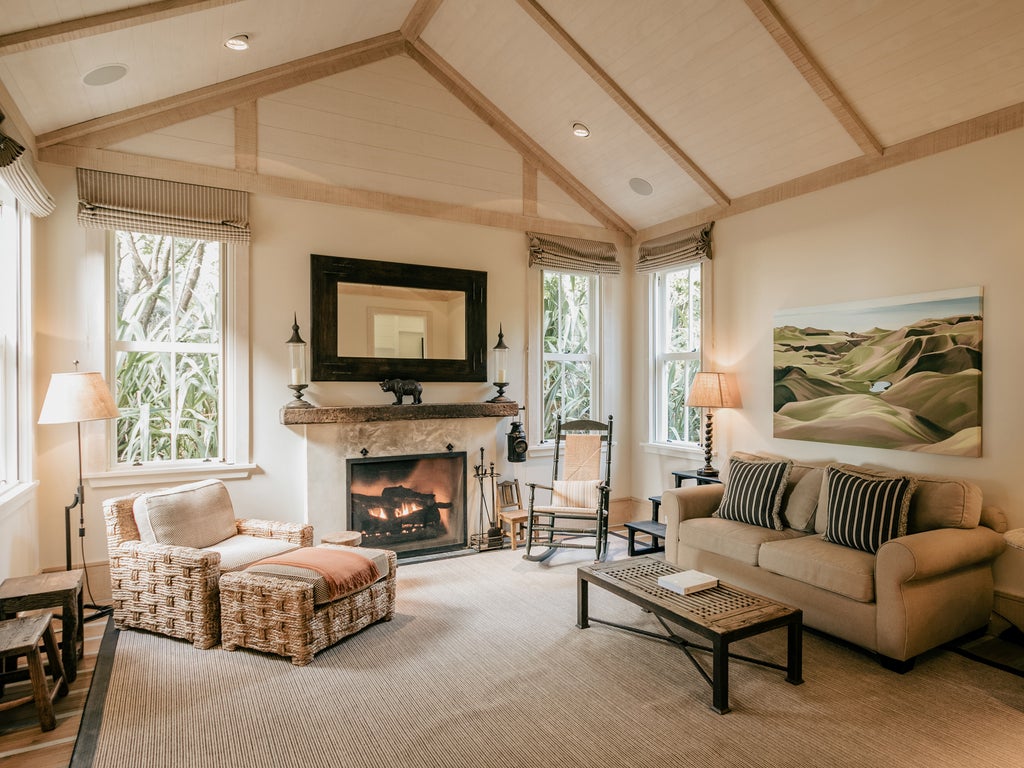 Luxury hilltop lodge overlooking dramatic cliffs and Bay of Hawke, featuring modern architecture with stone and wood finishes