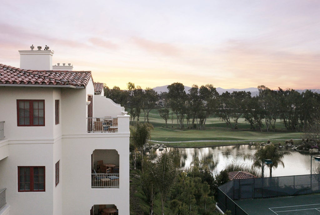 Elegant beachfront five-star resort featuring Spanish colonial architecture, palm-lined pools and ocean views along the California coast