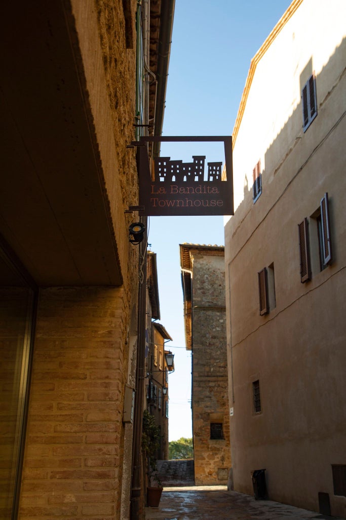 Elegant stone-walled boutique hotel nestled in Tuscan landscape, rustic chic interior with minimalist design and warm terracotta accents