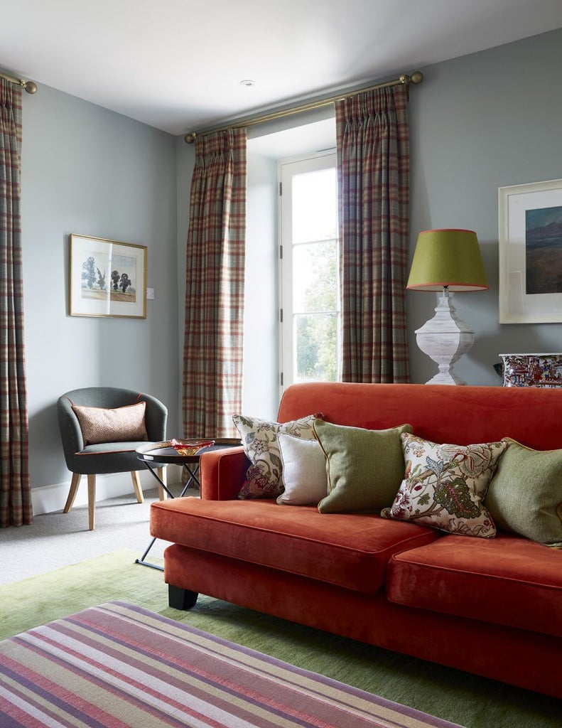 Warm, rustic cottage interior with soft lighting, plush furnishings, and traditional Scottish decor in a cozy family room at countryside accommodation