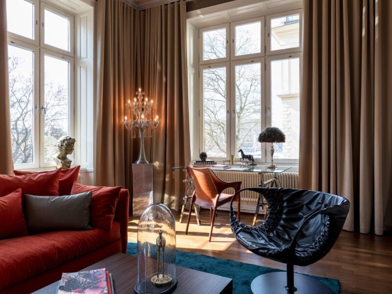 Luxurious boutique hotel room at Scenset Hotel overlooking Stockholm's waterfront, featuring elegant modern decor and soft neutral tones