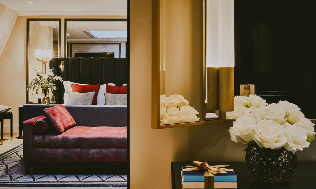 Elegant skylight suite with plush white bedding, contemporary furnishings, and soft natural light streaming through a large architectural skylight at The Mayfair Townhouse