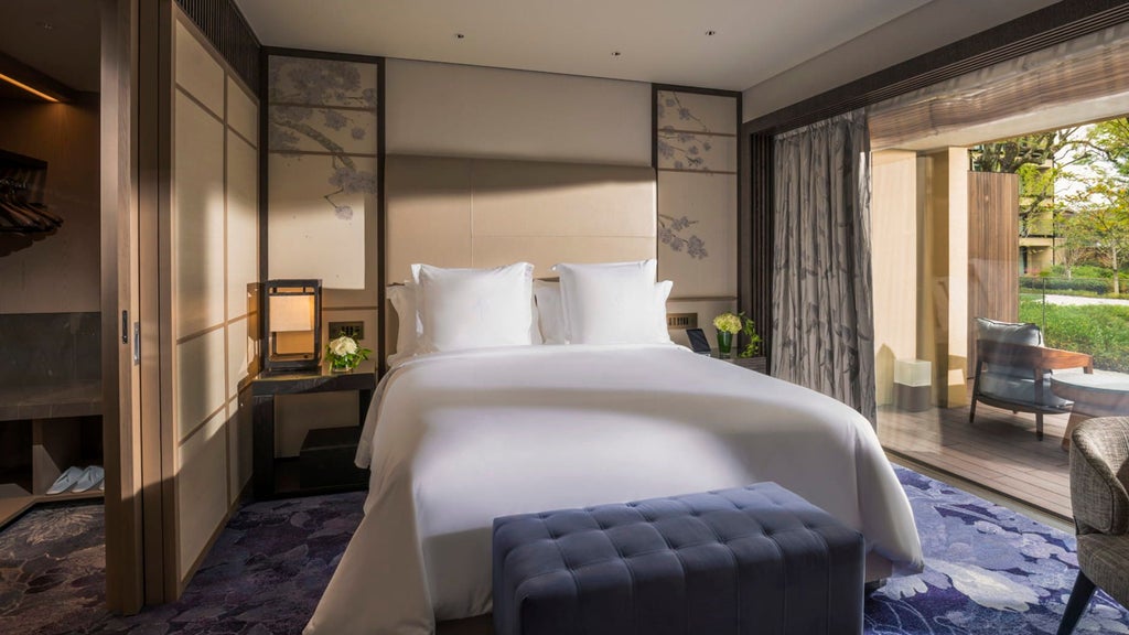 Spacious hotel residence with traditional Japanese garden views, modern furnishings, and elegant wooden decor in Kyoto's Four Seasons