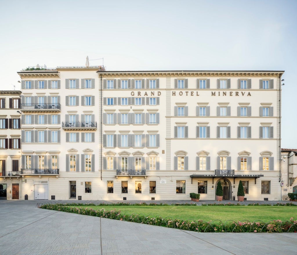 Elegant five-star hotel exterior with ornate Renaissance architecture, featuring a grand entrance and luxurious marble facade in Florence