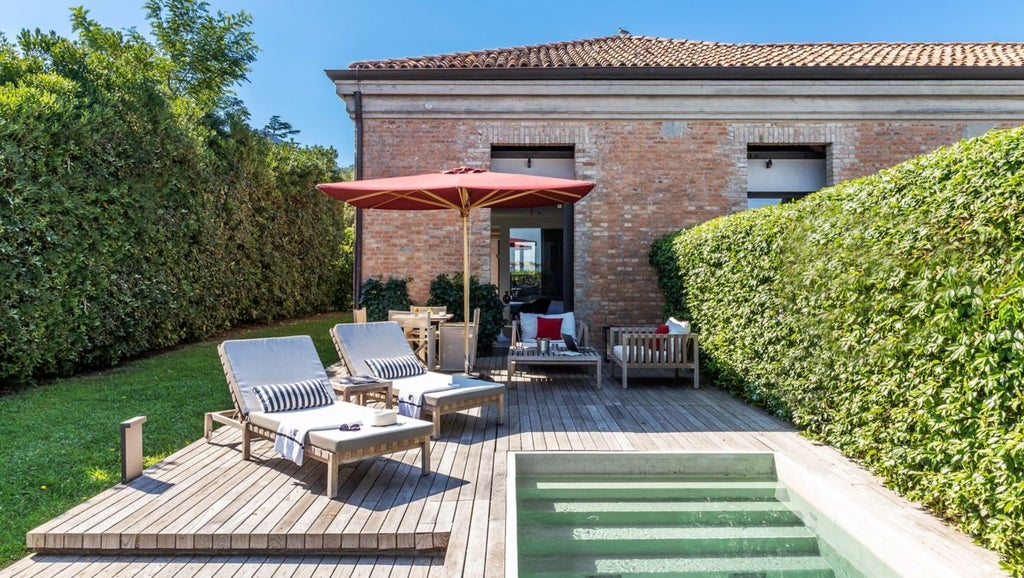 Elegant Venice hotel room featuring modern decor, king bed with crisp linens, floor-to-ceiling windows, and private pool views