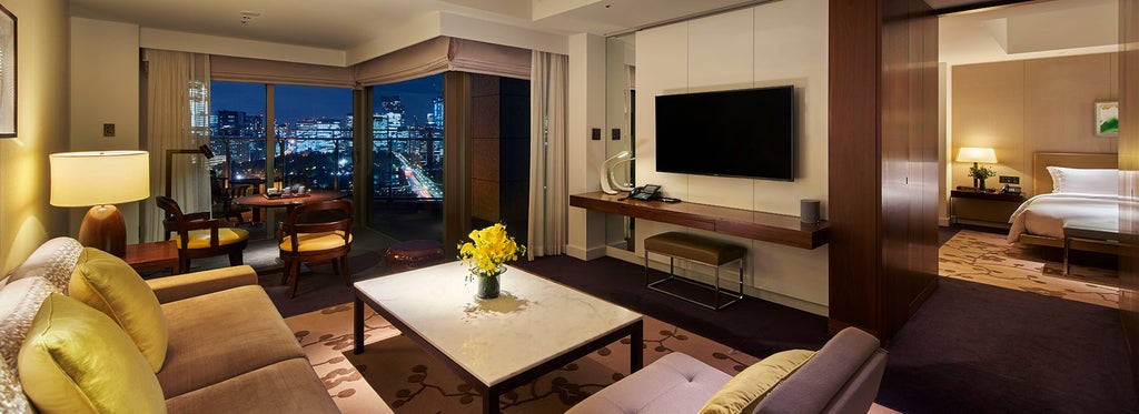 Elegant executive suite overlooking Tokyo skyline, featuring contemporary Japanese design with minimalist furnishings and floor-to-ceiling windows