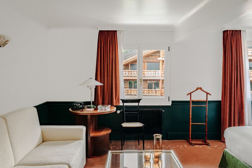 Minimalist Swiss alpine chalet suite with modern wood paneling, plush white bedding, expansive mountain view window, and contemporary designer furniture