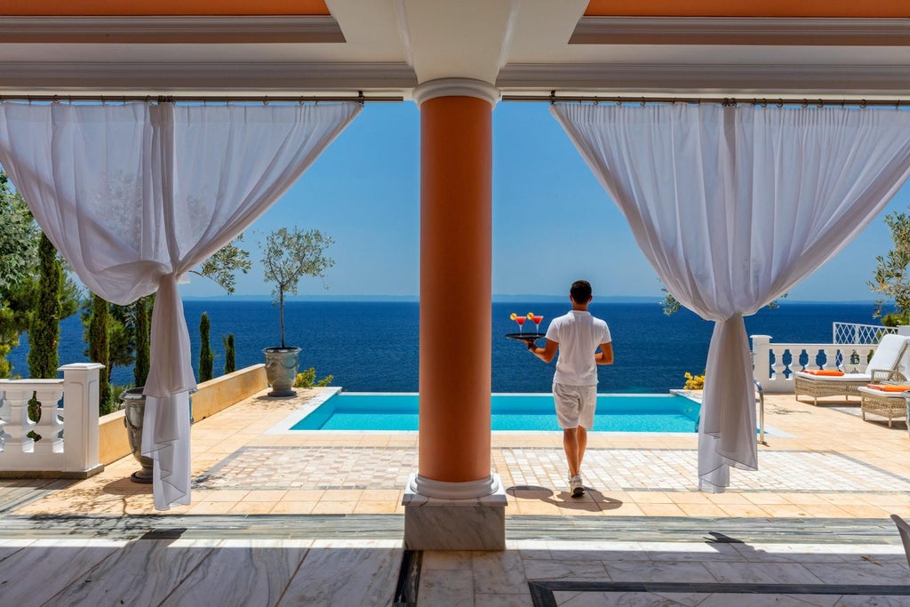 Luxurious white minimalist villa with panoramic Aegean Sea view, featuring sleek contemporary design, crisp linens, and elegant coastal decor in scenic Greece