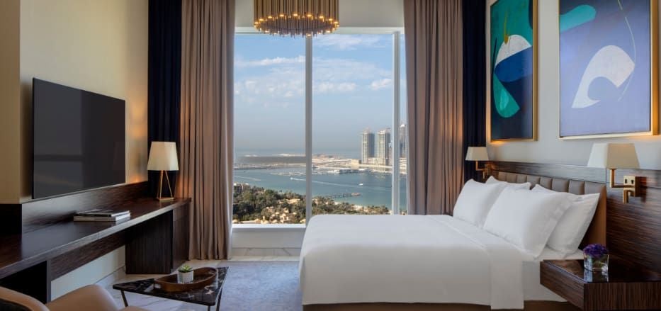 Luxurious studio suite with panoramic sea views, modern minimalist design, floor-to-ceiling windows, and elegant contemporary furnishings at Scenset Hotel Dubai