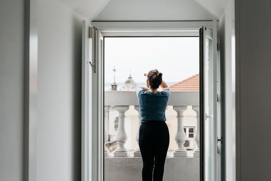 Spacious penthouse apartment in Lisbon with modern minimalist design, panoramic city views, and elegant white interior with sleek furnishings and natural light.