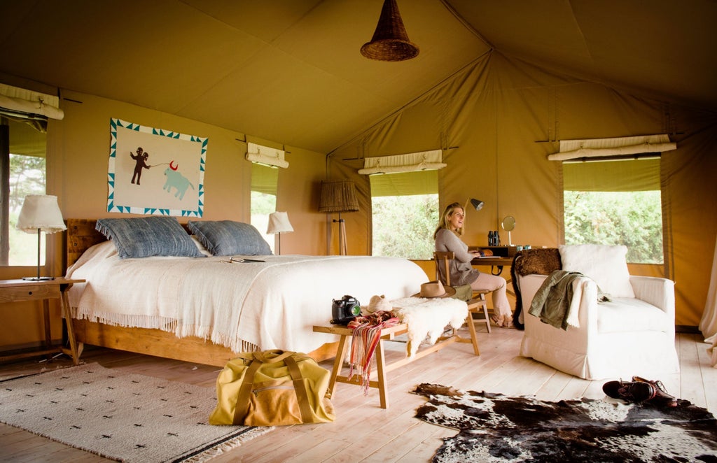 Luxurious safari tents perched on Ngorongoro Crater rim with sweeping savanna views, canvas walls and wooden deck at sunset