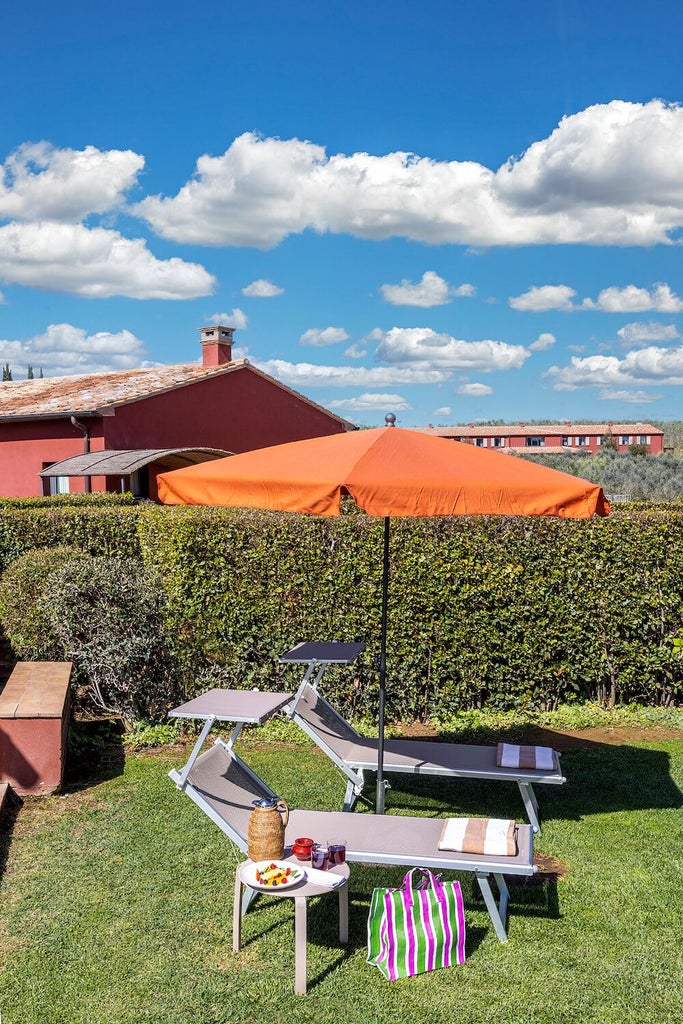 Elegant Italian prestige garden room with soft neutral tones, luxurious king bed, ornate wooden furnishings, and serene outdoor garden view at Locanda Rossa resort