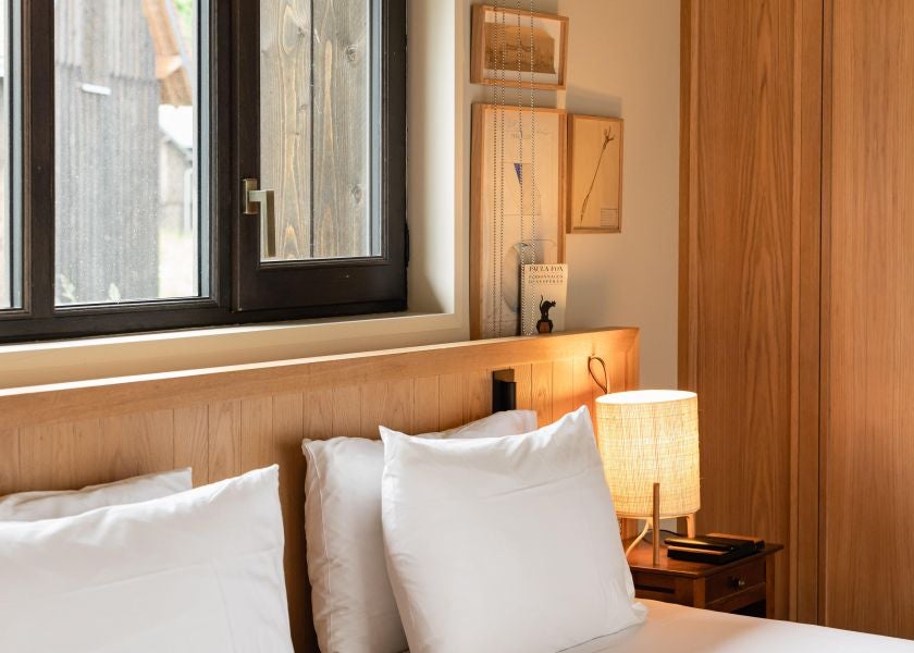 Elegant prestige room in Les Sources de Cheverny hotel, featuring plush bedding, soft neutral tones, and refined French countryside decor with natural light streaming in